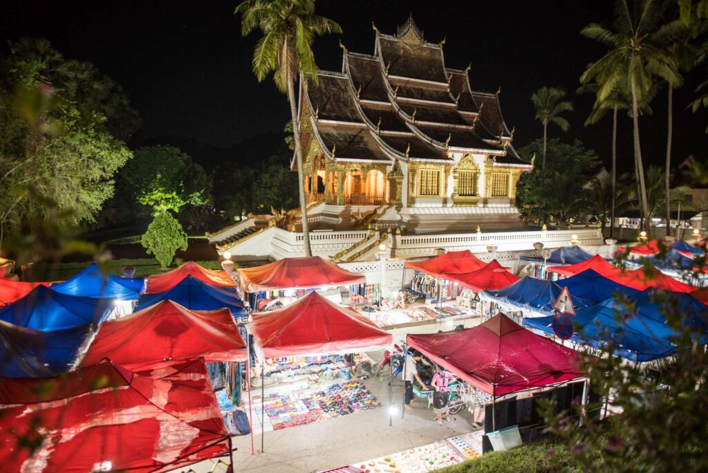 Night Market in Luang Prabang with Wat Haw Pha Bang in the background
